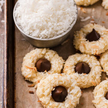 Baked macaroon kiss cookies on a parchment lined cookie sheet.