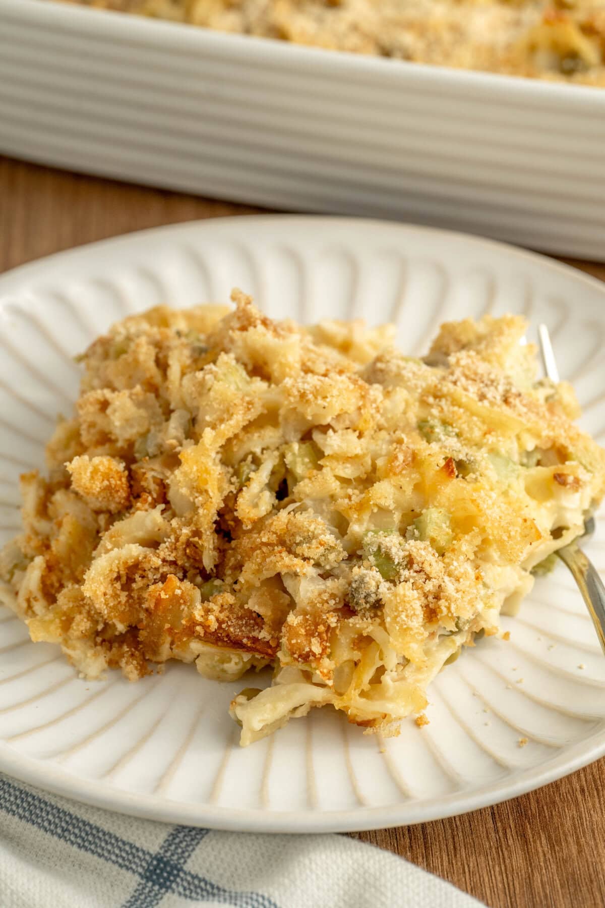 Old fashioned tuna noodle casserole served on a white plate.