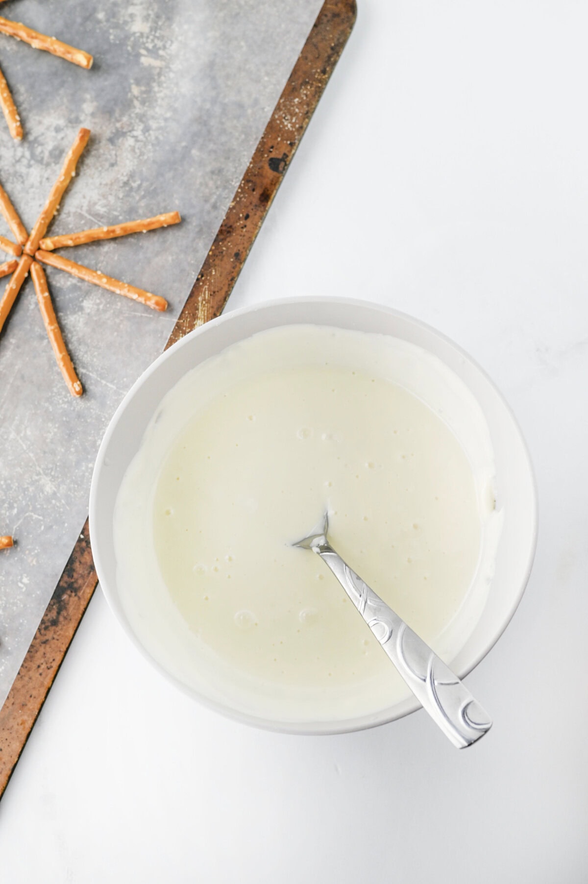 White melting wafers melted in a white bowl.