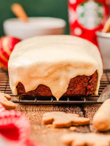 A side view of baked gingerbread quick bread on a wire cooling rack.